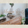 dresser with vase and books on it 